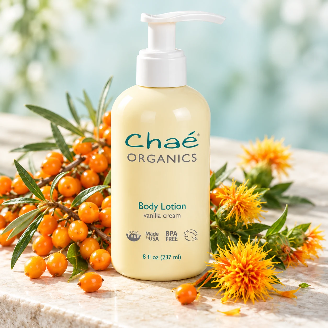 Body Lotion with sprigs of bright orange sea buckthorn berries and a few yellow-orange safflower blossoms