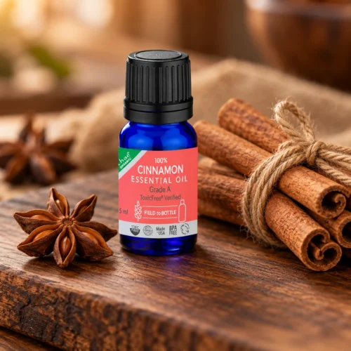 Chaé Cinnamon Essential Oil on a walnut board with cinnamon sticks and star anise