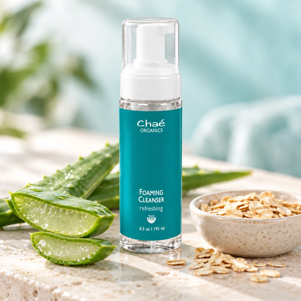 Foaming Cleanser with a split fresh aloe vera leaf and a small bowl of oats