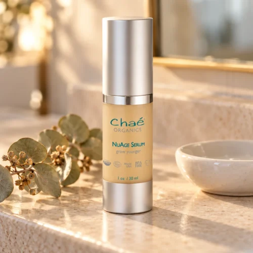 Chaé NuAge Peptide Serum on a stone vanity with dried eucalyptus
