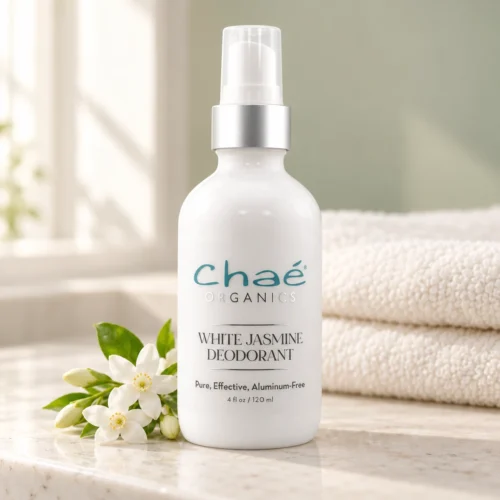 Chaé White Jasmine Deodorant - Aluminum-Free on a bathroom counter with jasmine flowers