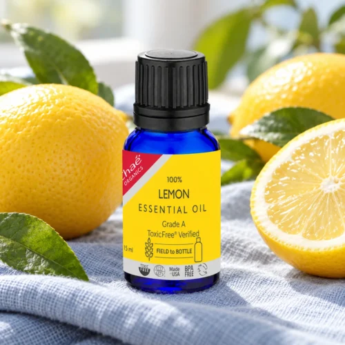 Chaé Lemon Essential Oil on linen beside fresh lemons