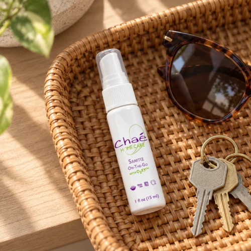 Chaé Sanitiz On-The-Go travel sanitizer spray in an entryway tray with keys and sunglasses