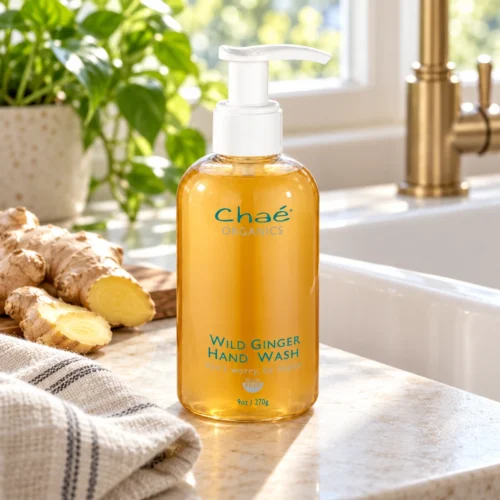 Chaé Wild Ginger Hand Wash by a kitchen sink with fresh ginger root