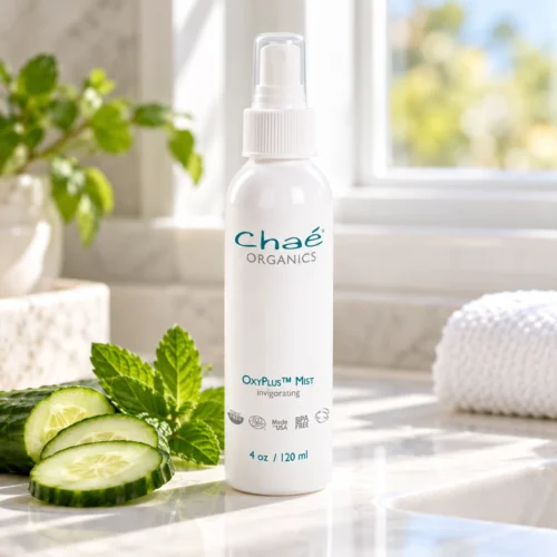Chaé OxyPlus Mist (Invigorating) on a sunny bathroom counter with cucumber slices and mint
