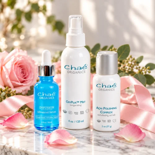 Chaé Glow and Love Collection — INFUSION Advanced Serum, OxyPlus Mist and Açai Polishing Complex with pink roses and a satin ribbon
