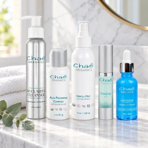 Chaé Pure Radiance Kit — NuClarity Cleanser, Açai Polishing Complex, Neroli Mist, VitalEyes and INFUSION Advanced Serum in a row on a marble counter