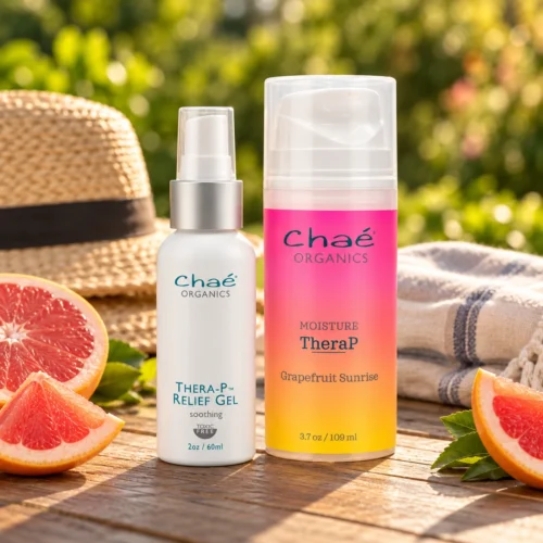 Chaé Calm & Moisture Duo — Thera-P Relief Gel and MOISTURE TheraP on a sunny patio table with grapefruit and a straw hat