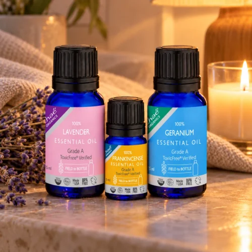 Chaé Calm Trio — Lavender, Frankincense and Geranium Rose Essential Oils on a bedside table by candlelight